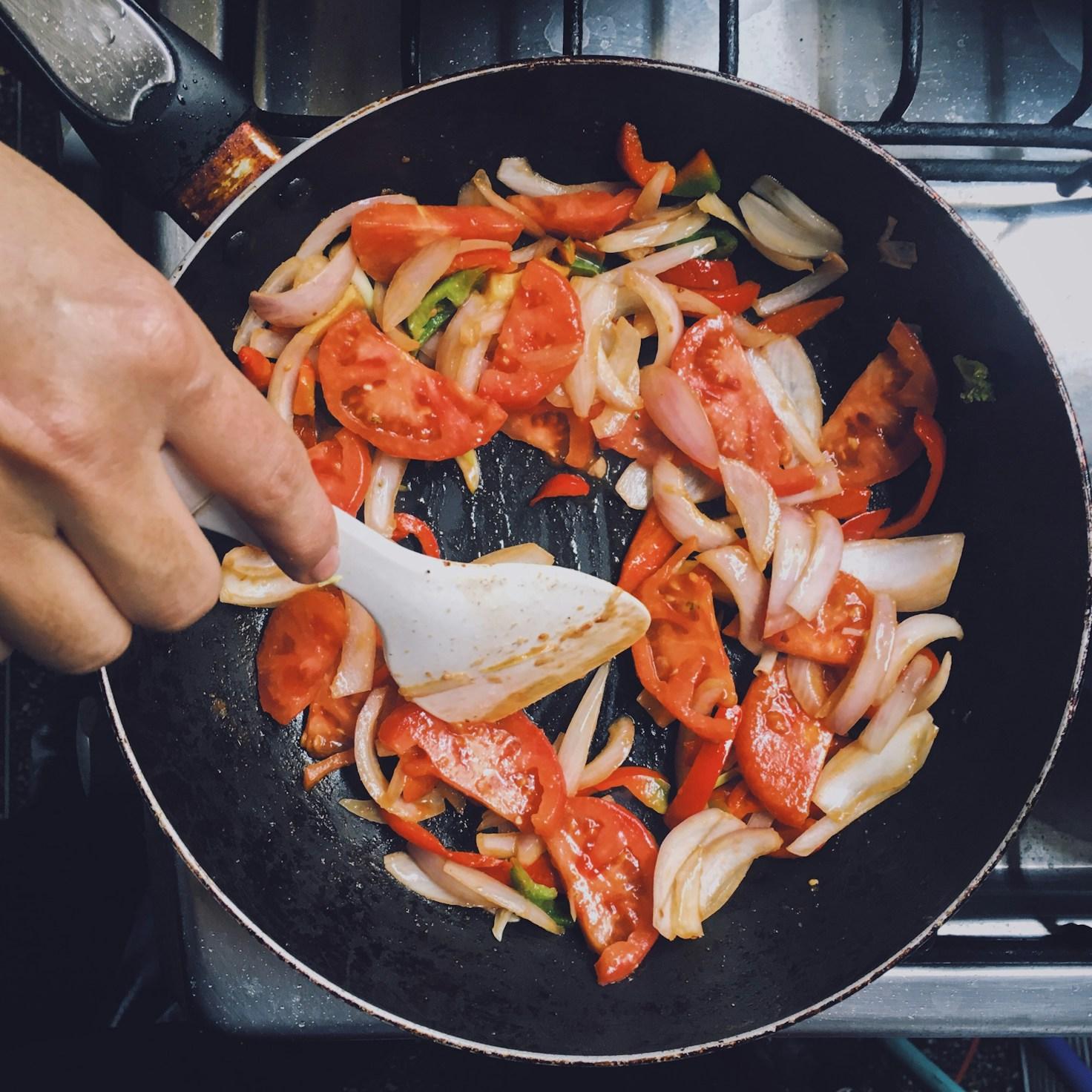 Community members collaborating in a modern kitchen space, sharing recipes and cooking techniques